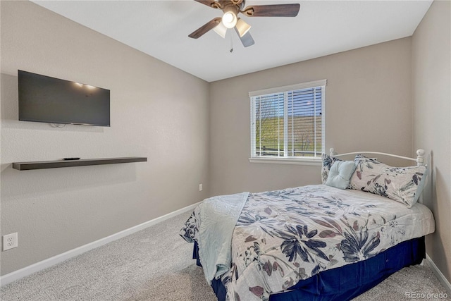bedroom with ceiling fan, carpet flooring, and baseboards