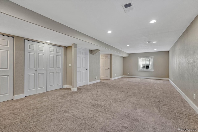 below grade area featuring visible vents, baseboards, and carpet