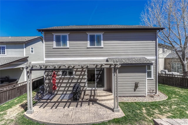 rear view of property featuring a patio, a pergola, fence, and a lawn