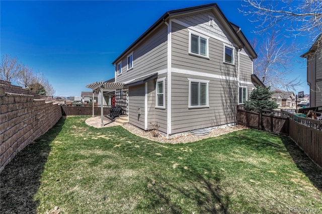 rear view of house with a pergola, a fenced backyard, and a lawn