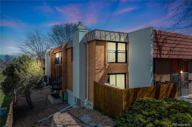 2917 S Locust St, Denver, CO 80222 - view of side of property with a chimney, brick siding, and metal roof