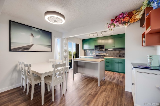 2917 S Locust St, Denver, CO 80222 - dining room featuring wood finished floors, a textured ceiling, and baseboards