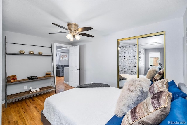 bedroom featuring a ceiling fan, a closet, and wood finished floors