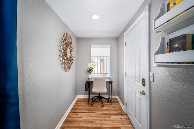 office with light wood-type flooring and baseboards