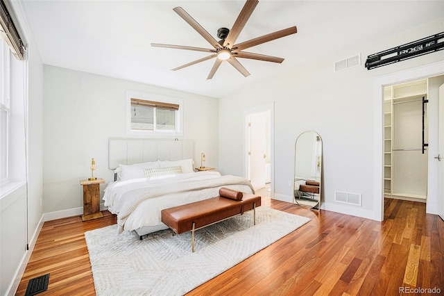 2931 W 20th Ave, Denver, CO 80211 - bedroom with light wood-style floors, baseboards, a spacious closet, ceiling fan, and a closet