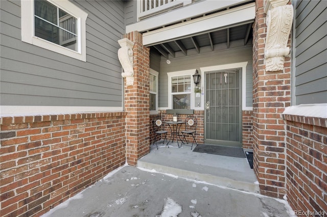 view of exterior entry with a porch