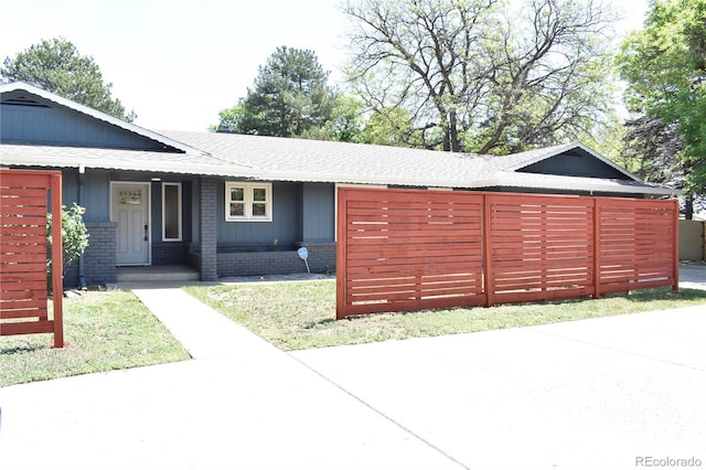 1320 S Lemay Ave, Fort Collins, CO 80524 - view of front facade with a shingled roof, a porch, and brick siding