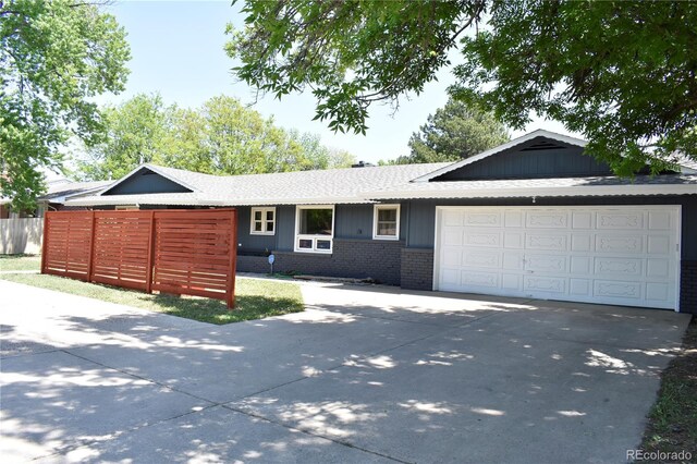 1320 S Lemay Ave, Fort Collins, CO 80524 - ranch-style home featuring brick siding, concrete driveway, a garage, and a shingled roof