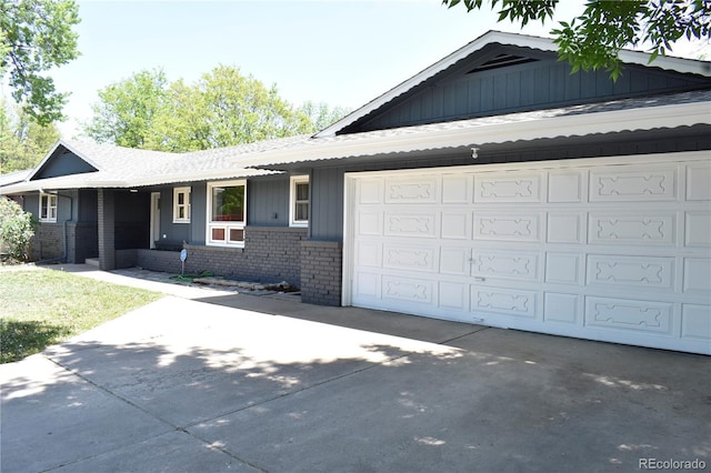 1320 S Lemay Ave, Fort Collins, CO 80524 - view of front of home with driveway, brick siding, an attached garage, and roof with shingles