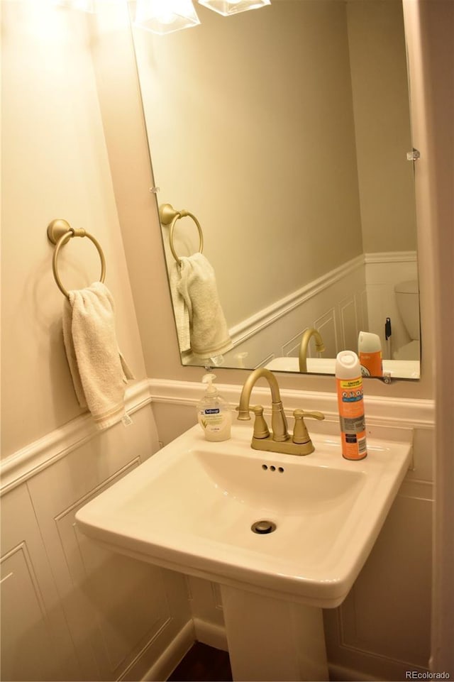 1320 S Lemay Ave, Fort Collins, CO 80524 - bathroom with wainscoting and a sink