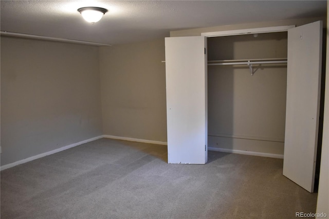 1320 S Lemay Ave, Fort Collins, CO 80524 - unfurnished bedroom with carpet flooring, a closet, baseboards, and a textured ceiling
