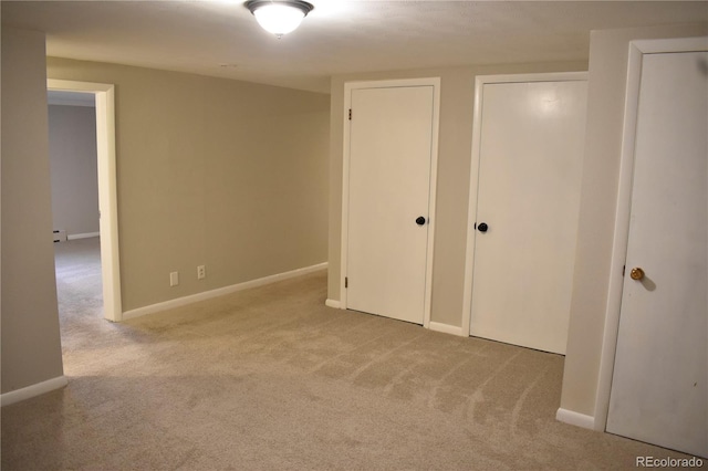 1320 S Lemay Ave, Fort Collins, CO 80524 - unfurnished bedroom with carpet, multiple closets, baseboards, and a baseboard heating unit