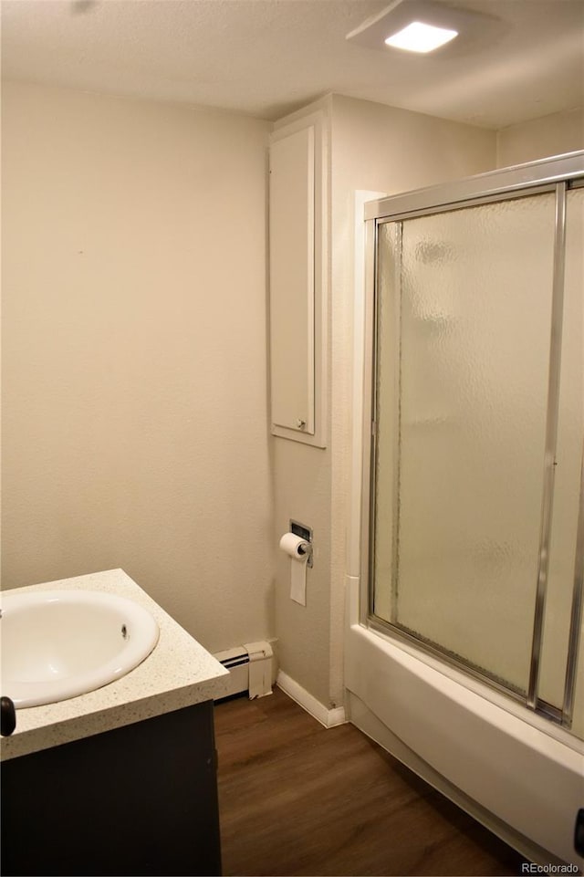 1320 S Lemay Ave, Fort Collins, CO 80524 - full bathroom featuring an enclosed shower, wood finished floors, vanity, baseboards, and baseboard heating