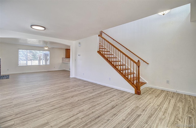 unfurnished living room with ceiling fan and light hardwood / wood-style floors