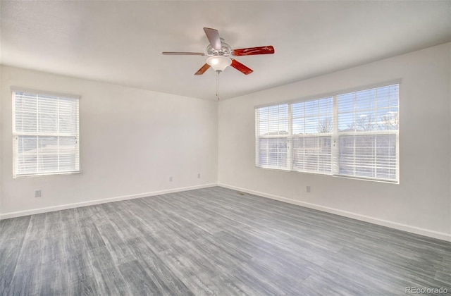 spare room with wood-type flooring and ceiling fan