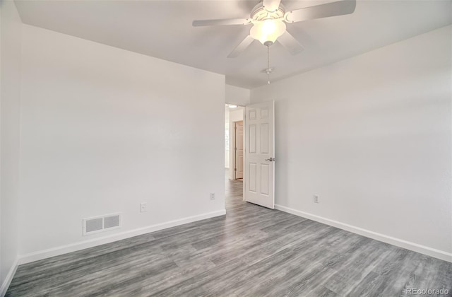 empty room with ceiling fan and wood-type flooring