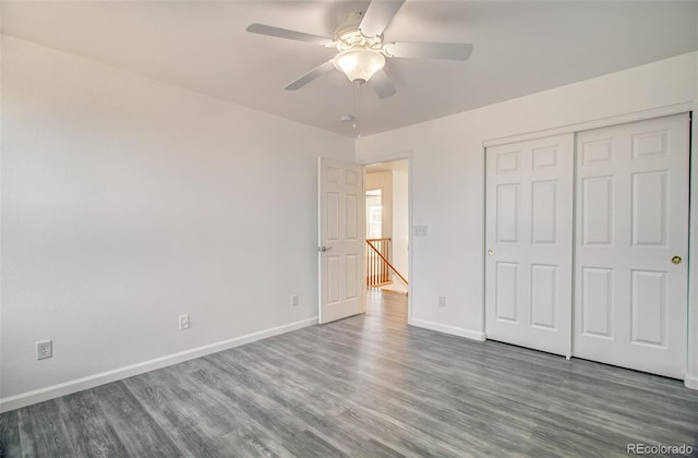 unfurnished bedroom featuring wood-type flooring, ceiling fan, and a closet