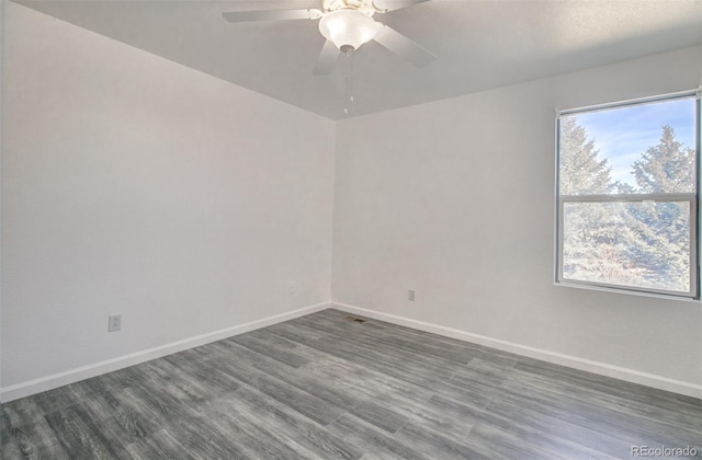 unfurnished room featuring ceiling fan and dark hardwood / wood-style flooring