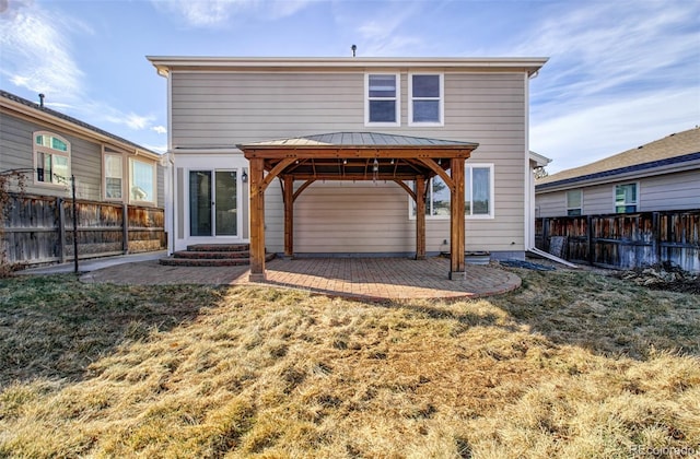 rear view of house featuring a yard, a gazebo, and a patio area