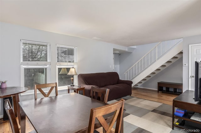 dining room with stairway and light wood finished floors