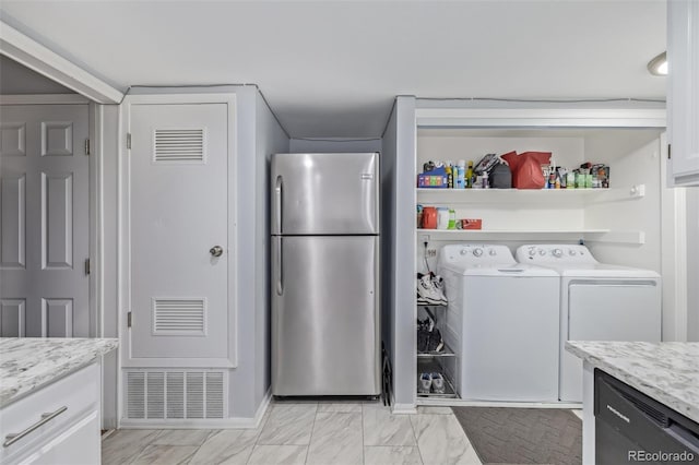 laundry area featuring laundry area, visible vents, independent washer and dryer, and marble finish floor