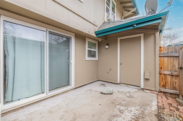 property entrance featuring a patio area and fence