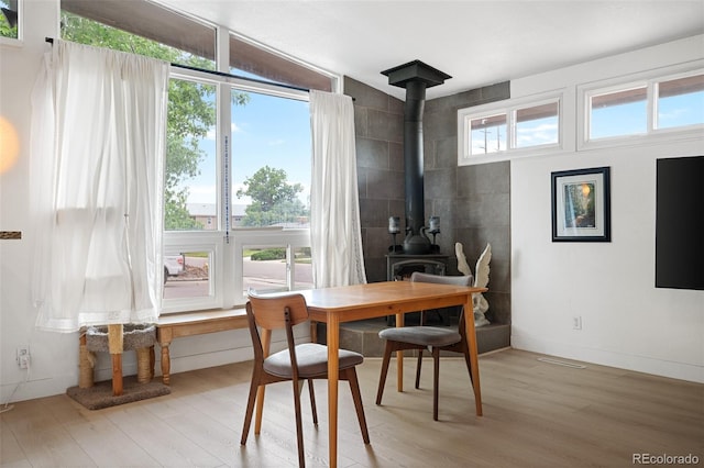 491 Campo St, Denver, CO 80221 - dining space featuring light wood-style flooring and a wood stove