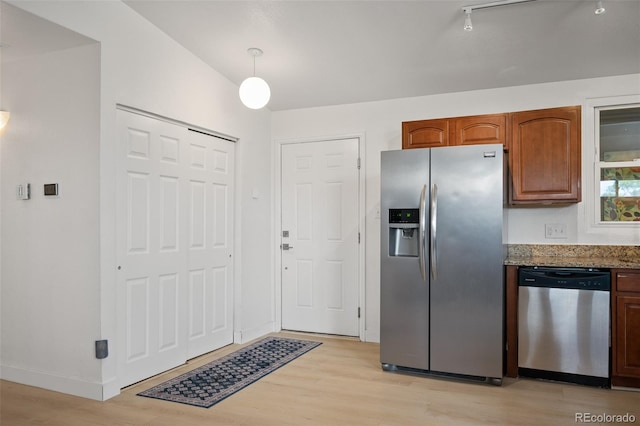 491 Campo St, Denver, CO 80221 - kitchen featuring appliances with stainless steel finishes, light wood-type flooring, dark stone counters, and pendant lighting