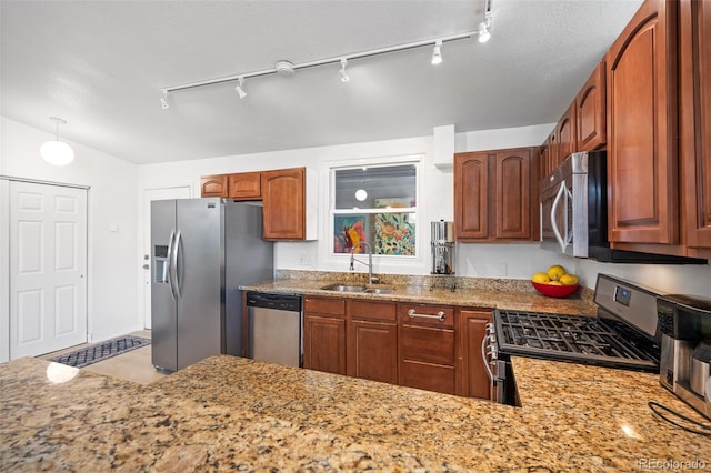 491 Campo St, Denver, CO 80221 - kitchen with appliances with stainless steel finishes, a sink, rail lighting, and light stone countertops
