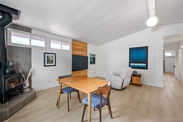 491 Campo St, Denver, CO 80221 - dining space with a wood stove, healthy amount of natural light, light wood-style floors, and vaulted ceiling