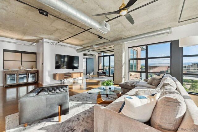 living room featuring ceiling fan and hardwood / wood-style floors