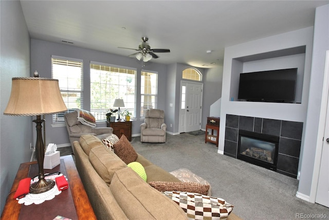 living room with baseboards, visible vents, ceiling fan, carpet, and a fireplace