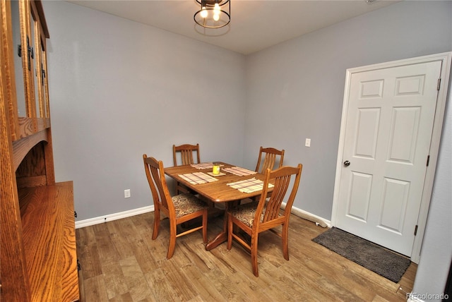 dining room featuring baseboards and light wood-style floors