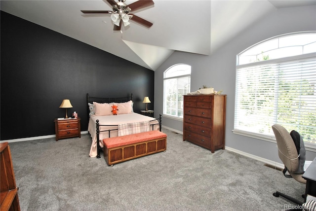 bedroom featuring vaulted ceiling, multiple windows, and light colored carpet