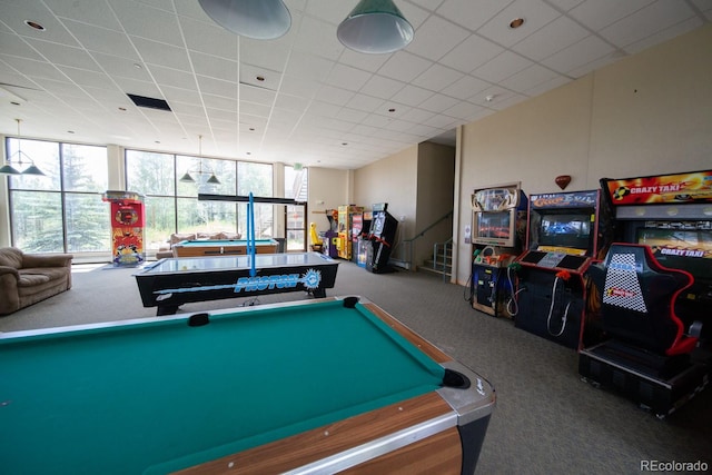 rec room with a wealth of natural light, a wall of windows, a paneled ceiling, and carpet floors