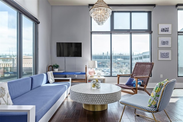 living area featuring an inviting chandelier and wood finished floors