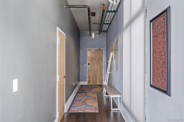 hallway with baseboards and wood finished floors