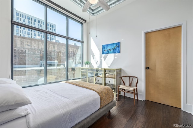 bedroom with floor to ceiling windows and hardwood / wood-style flooring