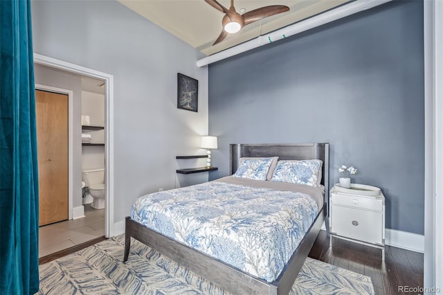 bedroom featuring baseboards, connected bathroom, ceiling fan, and wood finished floors