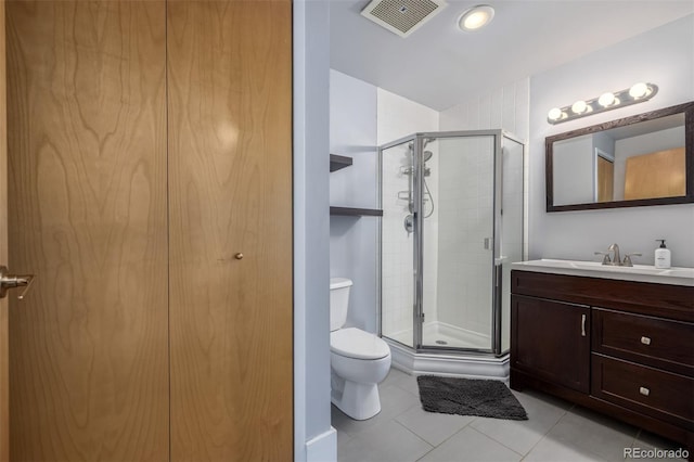 bathroom featuring vanity, toilet, tile patterned floors, visible vents, and a stall shower