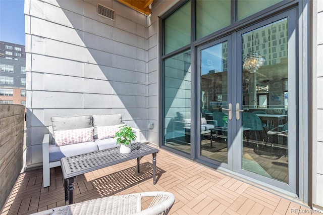 balcony featuring visible vents and an outdoor hangout area