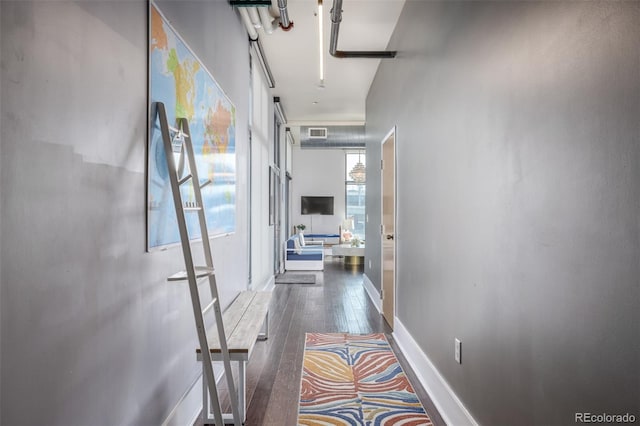 hallway featuring hardwood / wood-style flooring and visible vents