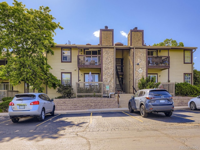 8680 Allison St Unit O, Arvada, CO 80005 - view of building exterior featuring uncovered parking and stairway