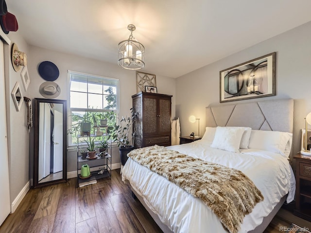 8680 Allison St Unit O, Arvada, CO 80005 - bedroom with a chandelier and dark wood-style floors