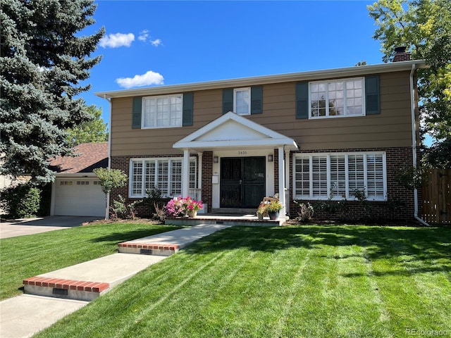 view of front of home with a garage and a front yard