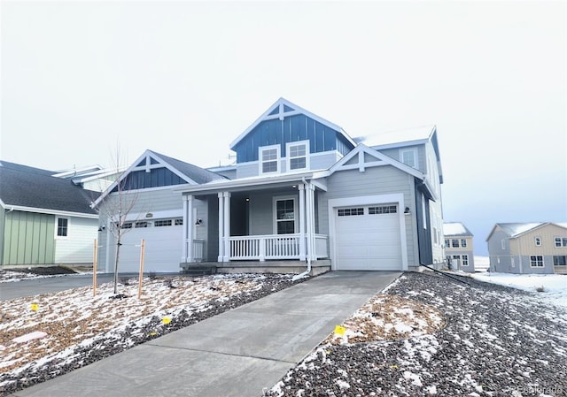 view of front of home featuring a garage, board and batten siding, a porch, and concrete driveway