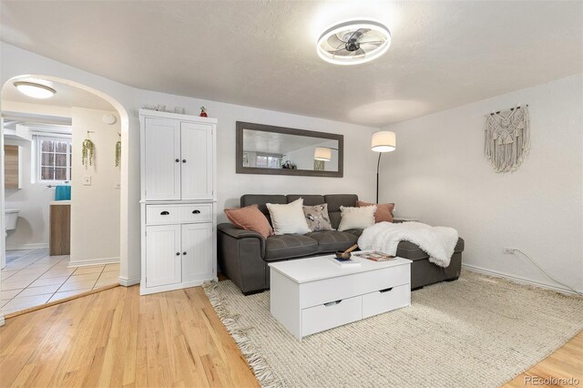 living room featuring a textured ceiling and light hardwood / wood-style floors