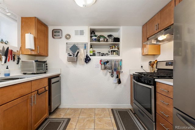 kitchen featuring stainless steel appliances and light tile patterned floors