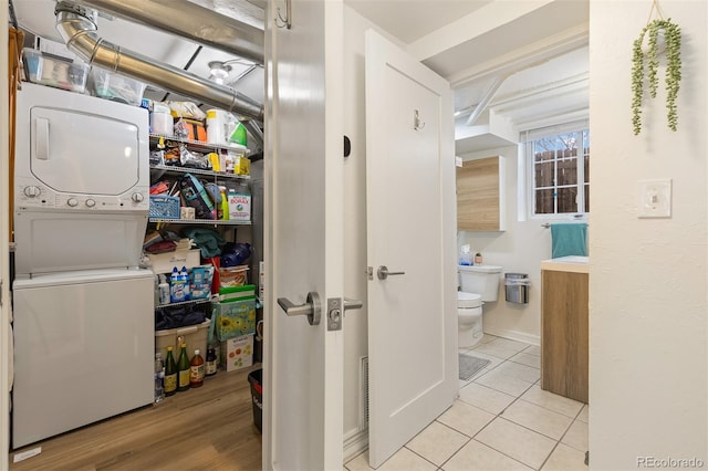 pantry with stacked washer and dryer