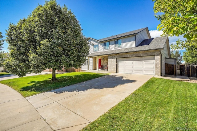 traditional home featuring driveway, fence, a front lawn, and brick siding